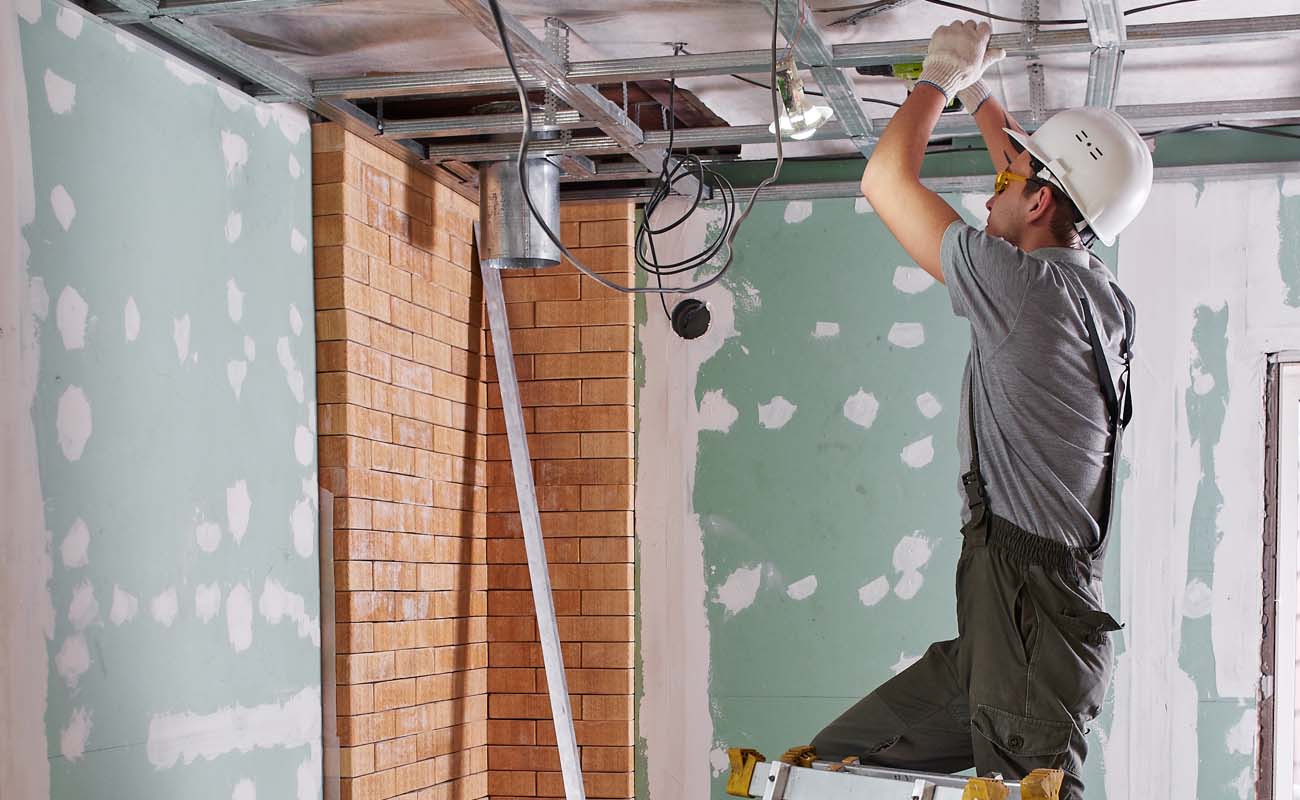 Technician Performing Maintenance on Ceiling