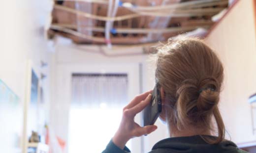 Homeowner Making a Phone Call About Ceiling Issues